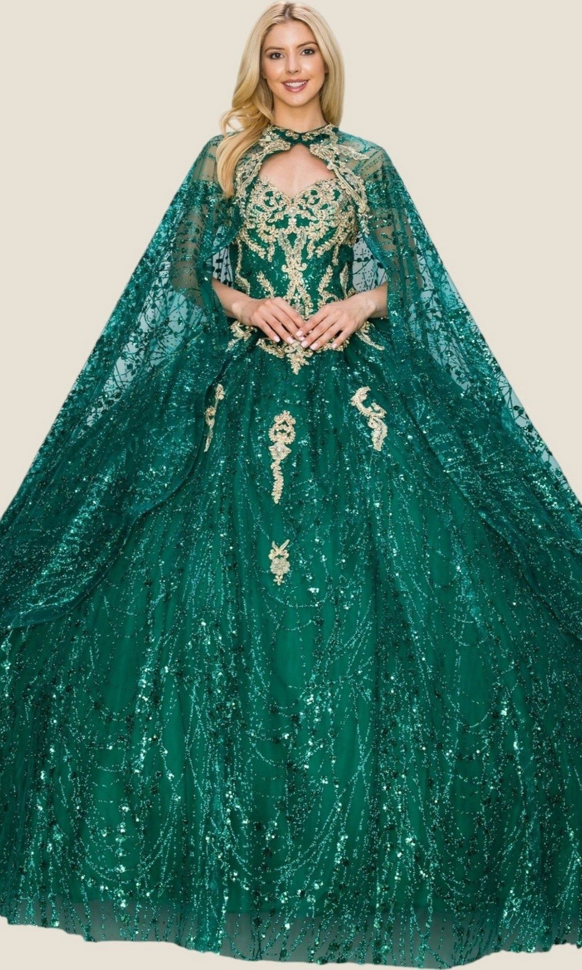A woman wearing the Quinceanera Dress 4201 by Cinderella Couture—a green, floor-length ball gown adorned with gold embroidery and complemented by a matching sequined cape—stands against a plain background, radiating elegance.